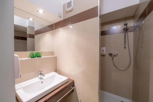 a bathroom with a sink and a shower at Parkhotel Eisenstadt in Eisenstadt