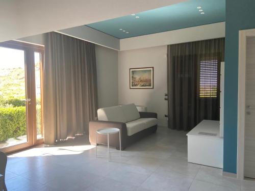 a living room with a couch and a table at Villa Torre degli Ulivi in Corigliano Calabro