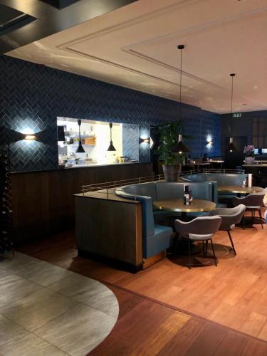 a restaurant with tables and chairs and a bar at Hotel Grandcafe De Doelen in Franeker