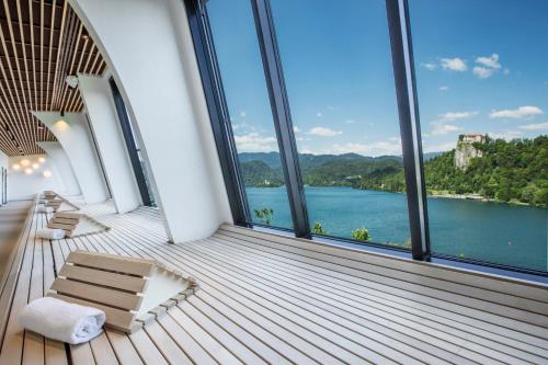 a room with large windows and a view of a lake at Hotel Park - Sava Hotels & Resorts in Bled
