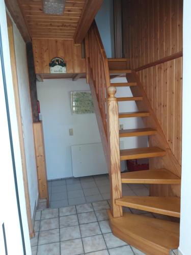 a staircase leading up to a garage with a door at de lüt Ferienhof Jameln in Jameln
