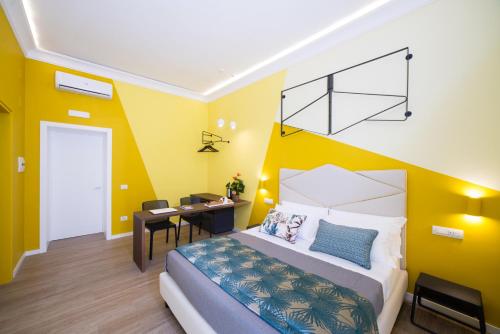 a bedroom with a bed and a desk in it at Mediterra in Castellammare di Stabia