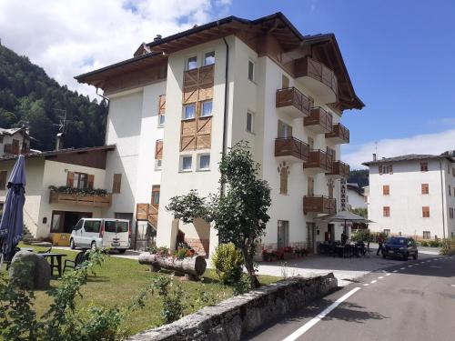 a large building on the side of a street at Hotel Aurora in Cavedago
