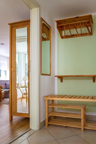 a living room with a table and a mirror at Ferienhaus Giesela **** in Wernigerode