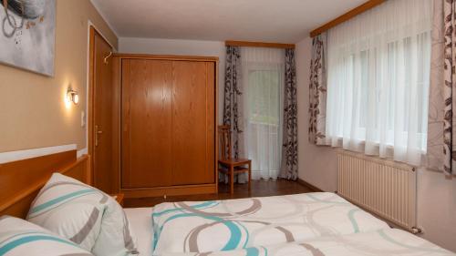 a small bedroom with a bed and a window at Apart Bel Ami in Kappl