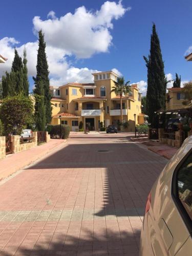 a car parked in front of a large house at Beautiful Regina gardens in Paphos City