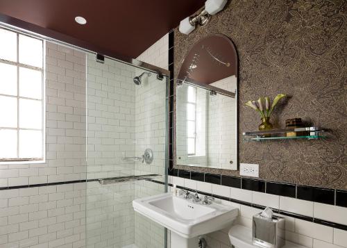 a bathroom with a sink and a mirror at Graduate Evanston in Evanston