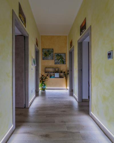 an empty hallway with two open doors in a room at R&B mediterraneo in Bosa