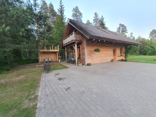 a house with a pavilion with a brick patio at Rīti Siguldā in Stīveri