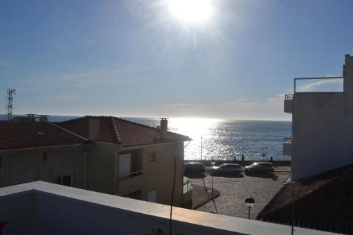 a view of the ocean from the balcony of a building at Casas dos Seixos in Moledo