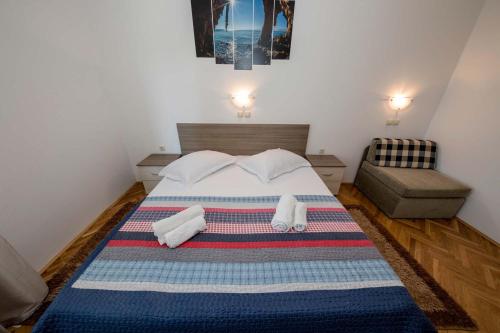a bedroom with a bed with towels on it at Paradise Apartments in Lopar