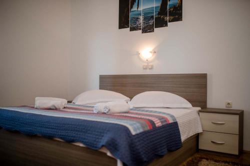 a bedroom with a bed with two towels on it at Paradise Apartments in Lopar