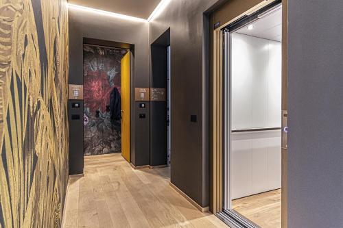a hallway with doors and a painting on the wall at LEONI DI COLLALTO PALACE in Treviso