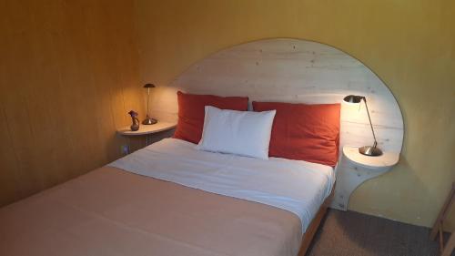 a bedroom with a bed with two lamps on it at Le grand souffle in Dolus-d'Oléron