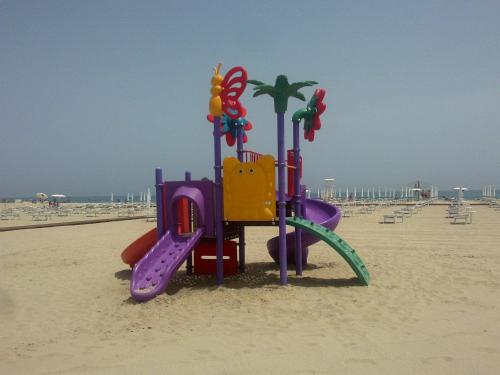 a playground in the sand on the beach at Residence Nettuno in Campomarino