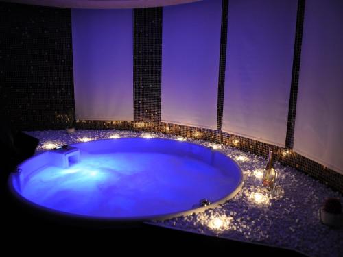 a bathroom with a large tub with lights in it at Villa i SPA Stević in Veliko Gradište