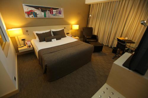 a hotel room with a large bed and a television at CPAnkara Hotel in Ankara