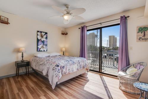 a bedroom with a bed and a balcony at Tarpon 10 in Panama City Beach