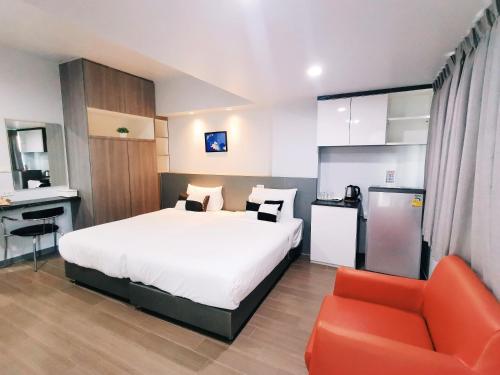 a bedroom with a bed and a desk and a chair at Star Sukhumvit in Bangkok