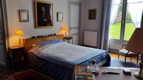 une chambre avec un lit avec une couette bleue dans l'établissement La Violiere, à Rouziers-de-Touraine