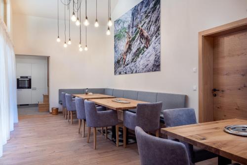 a dining room with a long table and chairs at CHALET MONTIS in Flachau