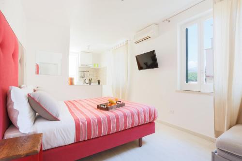 a white bedroom with a bed and a window at SorrentoVibes - Central Sorrento Apartment by PiazzaTasso&OldTown in Sorrento