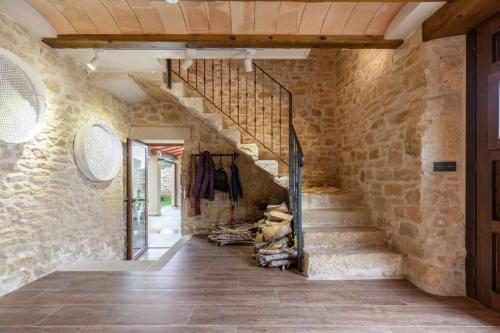 a hallway with a staircase in a stone wall at El Gresol - Naturaleza y Relax in Senant