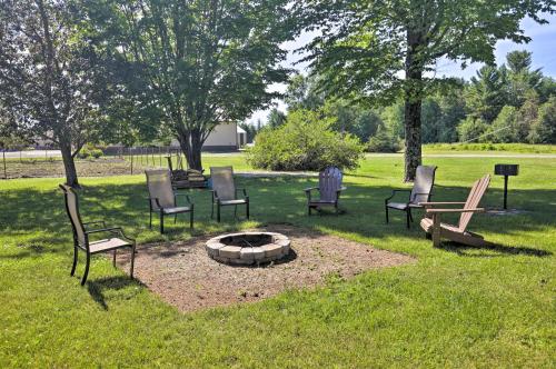 a group of chairs sitting around a fire pit at Simple Cranberry and Wine Farm Home with Fire Pit! in Eagle River