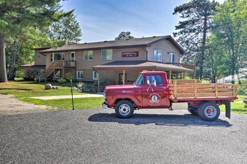 a red truck parked in front of a house at Simple Cranberry and Wine Farm Home with Fire Pit! in Eagle River
