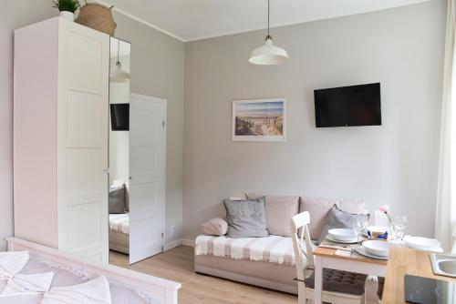 uma sala de estar com um sofá e uma mesa em Portofino Seaside Apartments em Międzyzdroje