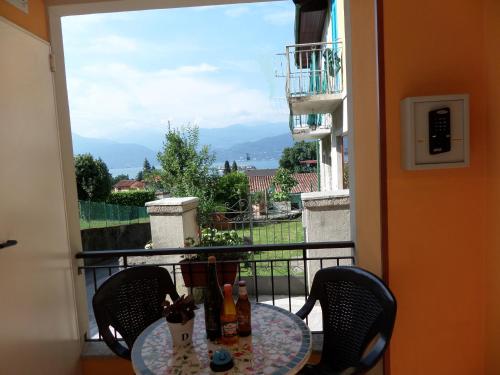 a table and chairs on a balcony with a view at Guesthouse Serena in Stresa