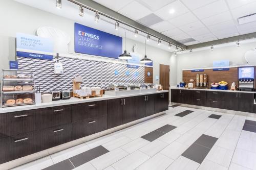 a fast food restaurant with a doughnut counter at Holiday Inn Express & Suites - Springfield North by IHG in Springfield