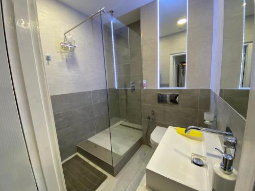 a bathroom with a shower and a sink and a toilet at Self catering Skipton town centre apartment in Skipton