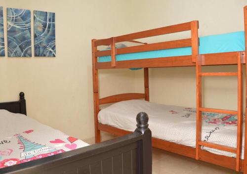 a bedroom with two bunk beds and a bed at Casa en Altata Las Aguilas, Nav. Sinaloa in Altata