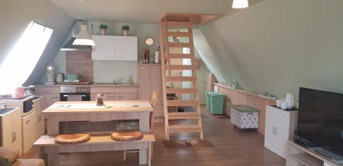 a kitchen with a staircase and a living room at Ferienhaus Kleine Auszeit in Gossersweiler-Stein