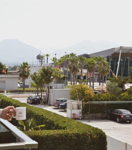 a person taking a picture of a parking lot at Airport Garden Hotel in Rinas