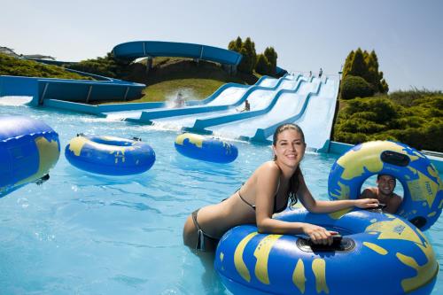 a woman is riding on an inflatable raft in a water park at Mediteran Homes with Terme Čatež Tickets in Čatež ob Savi