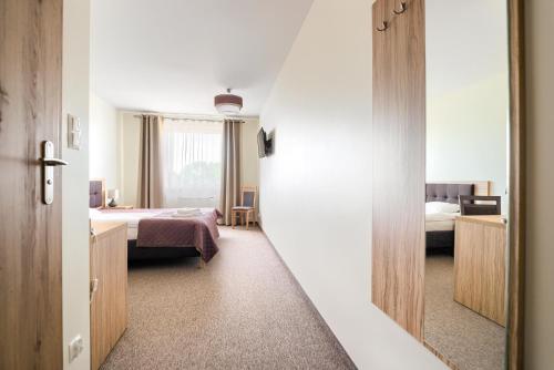 Ένα ή περισσότερα κρεβάτια σε δωμάτιο στο Hotel Bosak