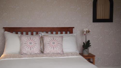 a bedroom with a bed with two pillows at Skerryvore in Oban