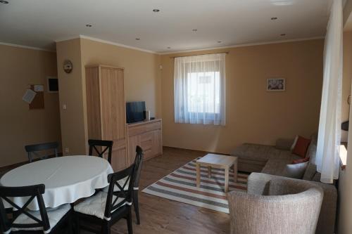 a living room with a table and a couch at Boróka 2 Vendégház in Szentes