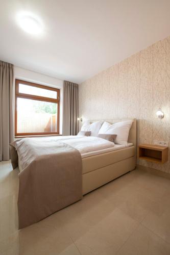 Ein Bett oder Betten in einem Zimmer der Unterkunft Rezidence Tři Studně