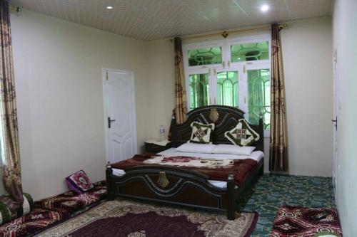 A bed or beds in a room at Hunza Heaven Guest House