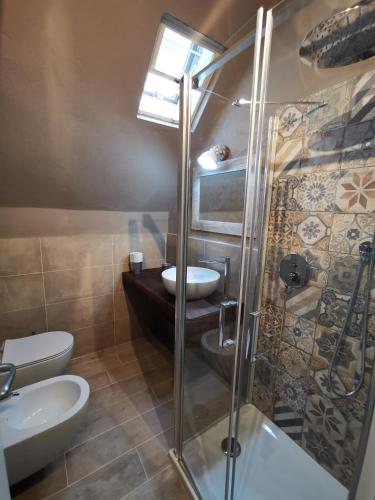 a bathroom with a shower and a toilet and a sink at Villetta graziosa sul mare in Forte Village