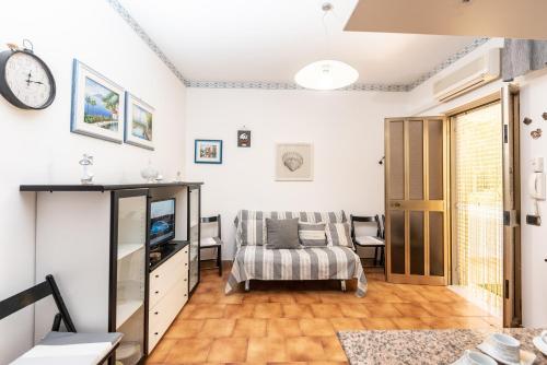 a living room with a couch and a tv at Casa Vacanza Sant'Erasmo Ginosa Marina in Ginosa Marina