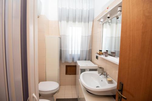 a bathroom with a white toilet and a sink at Casa Vacanza Sant'Erasmo Ginosa Marina in Ginosa Marina