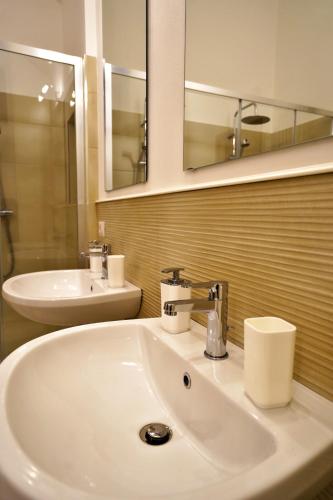 a bathroom with a white sink and a mirror at Malandrì B&B in Altamura