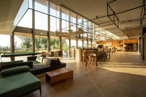 a large lobby with couches and a table at Novotel Itu Terras de São José Golf & Resort in Itu