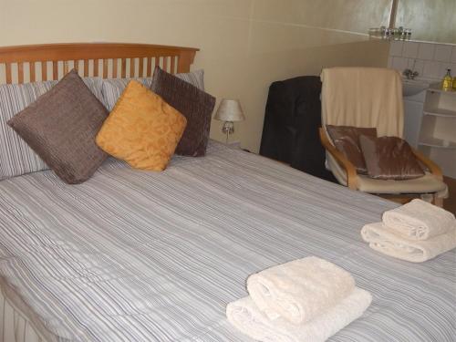 a bed with two towels on top of it at Rob Roy Guest House in Folkestone