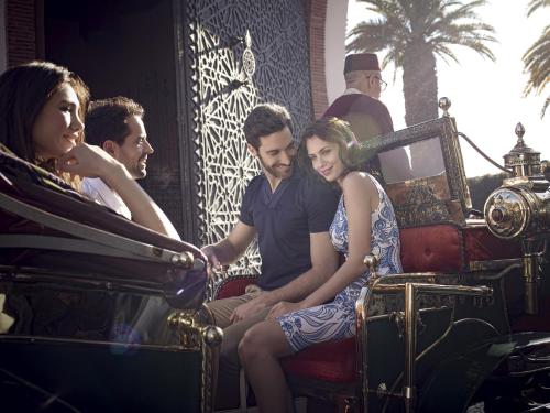 a group of people sitting on a roller coaster at Royal Mansour Marrakech in Marrakesh