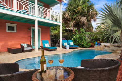 a bottle of wine sitting on a table next to a pool at Bayfront Marin House in St. Augustine